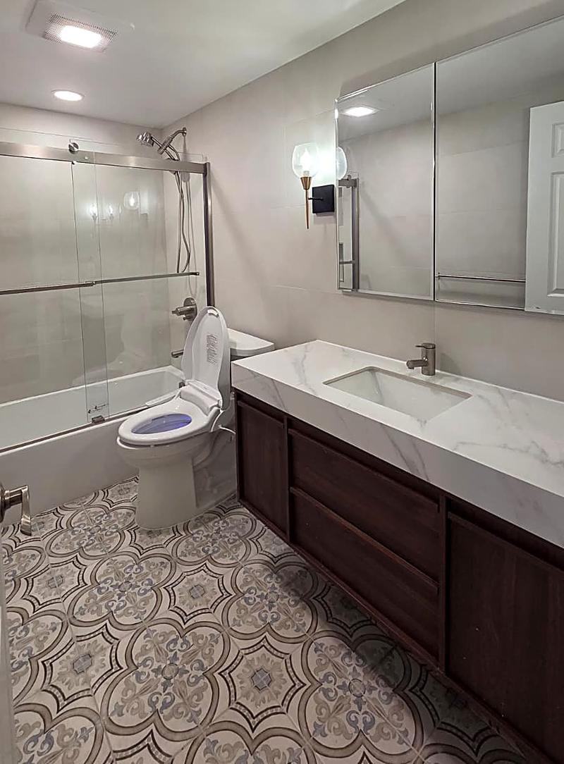 Bathroom remodel with marble vanity top and patterned tile floor by KJ Commercial in NJ